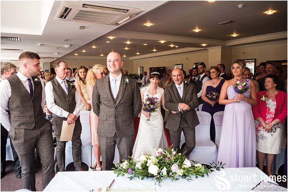 Documenting the entrance to the ceremony of the bridal party, showing the mood and emotion of the beautiful moment at The Moat House in Acton Trussell by Documentary Wedding Photographer Stuart James
