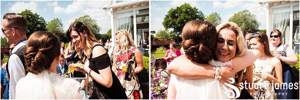 Creative candid photographs of the guests enjoying the wedding drinks at The Moat House in Acton Trussell by Documentary Wedding Photographer Stuart James