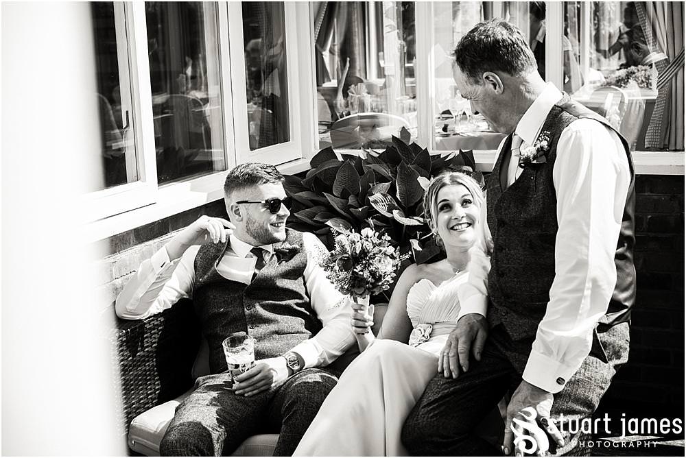 Candid photographs of the guests enjoying the wedding at The Moat House in Acton Trussell by Documentary Wedding Photographer Stuart James