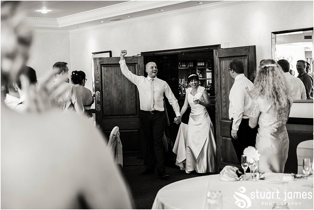 Capturing the energy during the fabulous entrance of the Bride and Groom at The Moat House in Acton Trussell by Documentary Wedding Photographer Stuart James