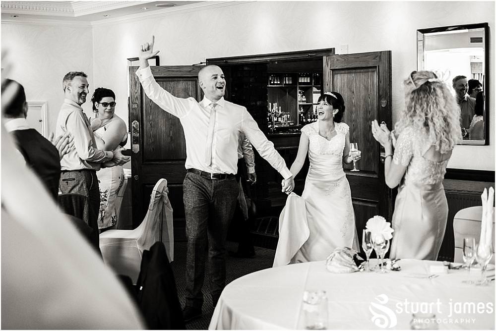 Capturing the energy during the fabulous entrance of the Bride and Groom at The Moat House in Acton Trussell by Documentary Wedding Photographer Stuart James