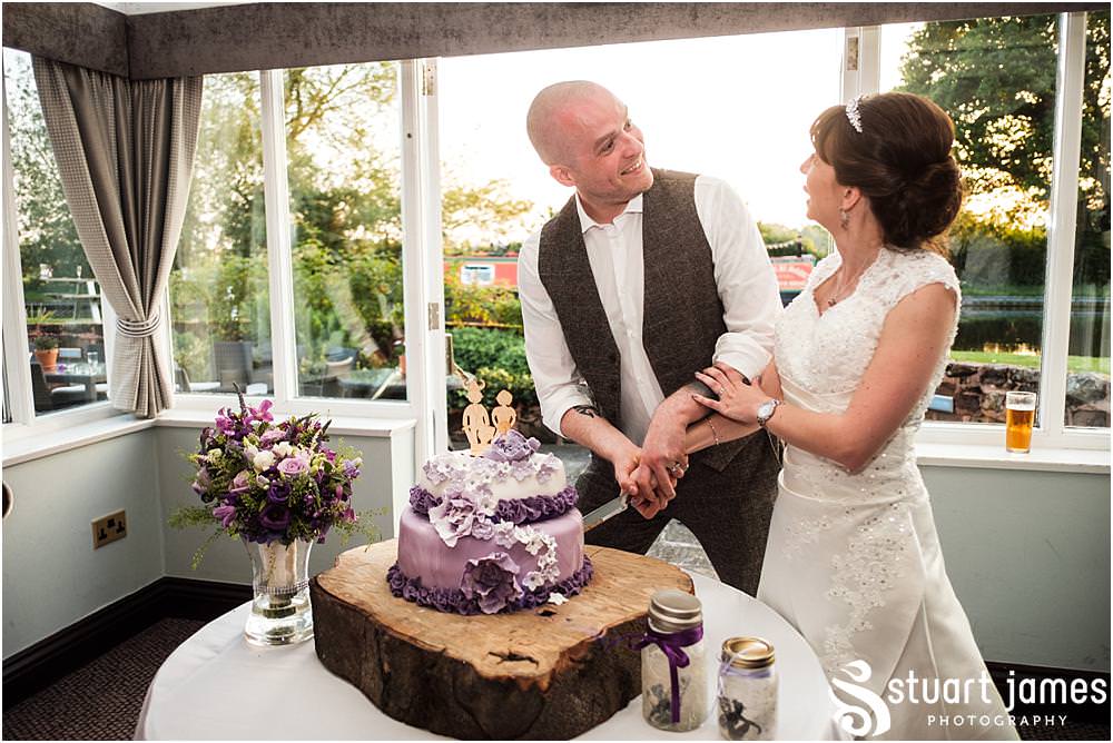 Cake cutting fun at The Moat House in Acton Trussell by Documentary Wedding Photographer Stuart James