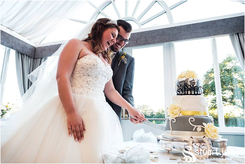 Cake cutting fun at The Moat House in Acton Trussell captured by Penkridge Wedding Photographer Stuart James