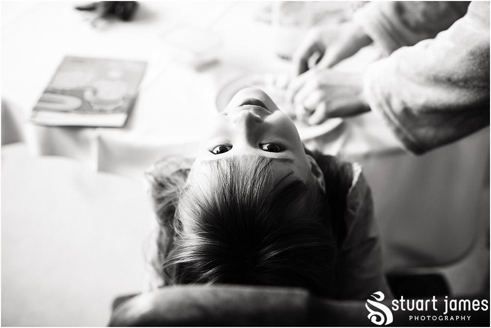 Creative candid photographs of the bridal preparations at Sandon Hall in Staffordshire by Documentary Wedding Photographer Stuart James
