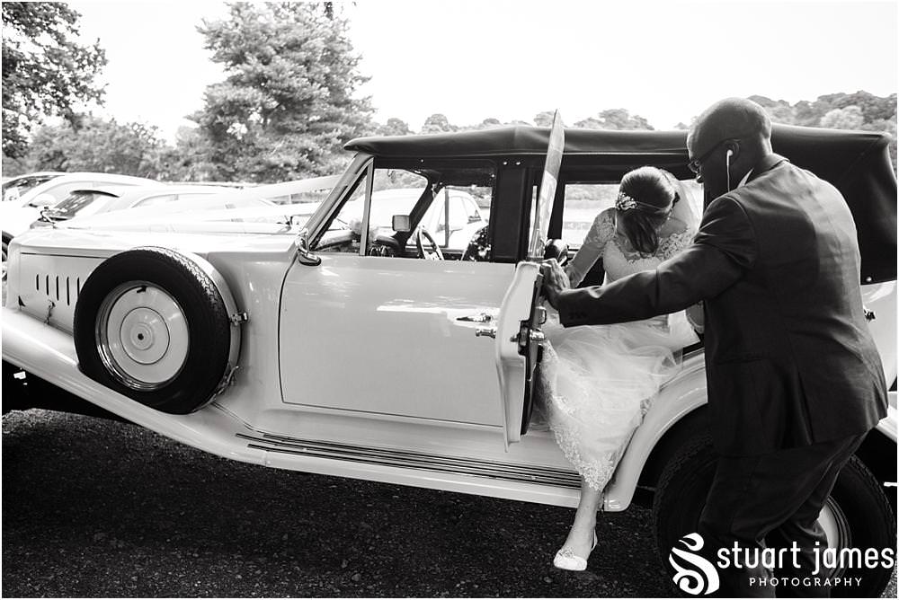Capturing the arrival of the bride with her father at All Saints Church in Sandon by Documentary Wedding Photographer Stuart James