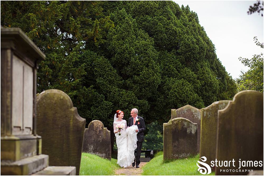 Capturing the arrival of the bride with her father at All Saints Church in Sandon by Documentary Wedding Photographer Stuart James