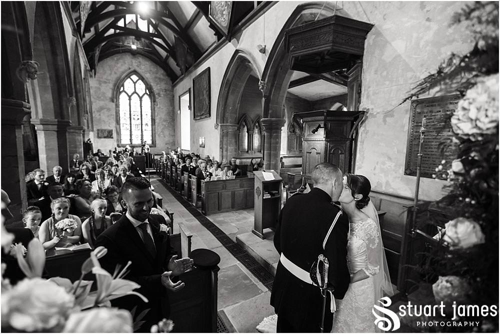 Unobtrusive storytelling wedding photography during the wedding ceremony at All Saints Church in Sandon by Documentary Wedding Photographer Stuart James