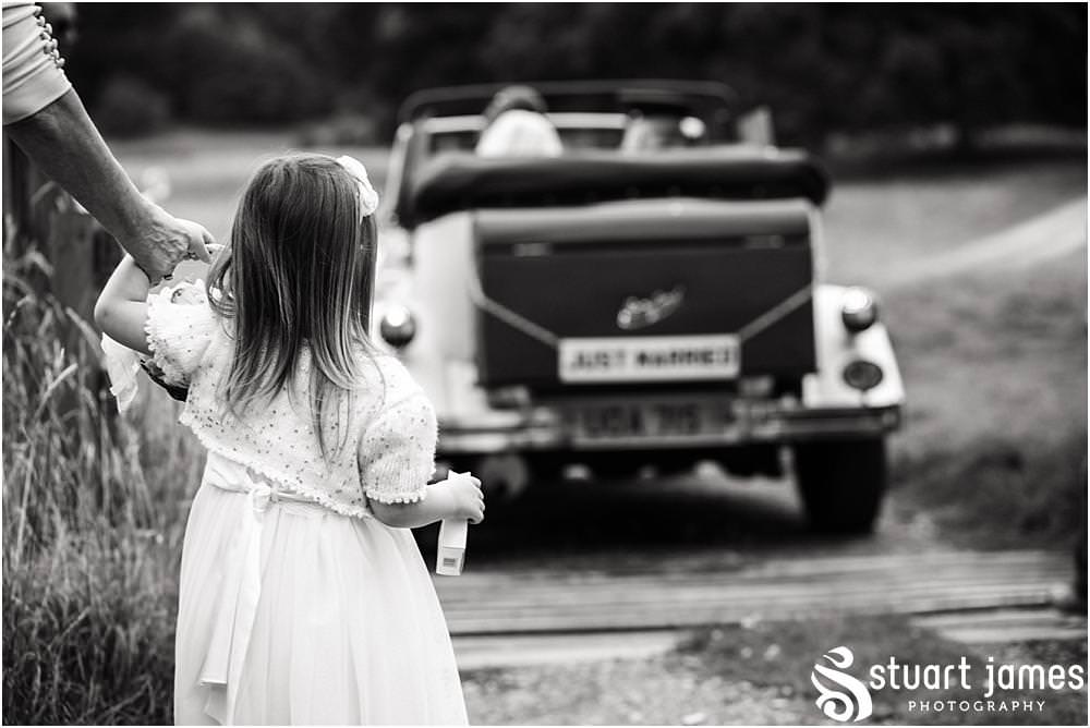 Creative documentary wedding photography as the bride and groom leave the church for the reception at Sandon in Staffordshire by Documentary Wedding Photographer Stuart James