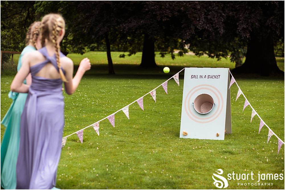 Capturing the fun of the afternoon as the guests relax and play the garden games at Sandon in Staffordshire by Documentary Wedding Photographer Stuart James