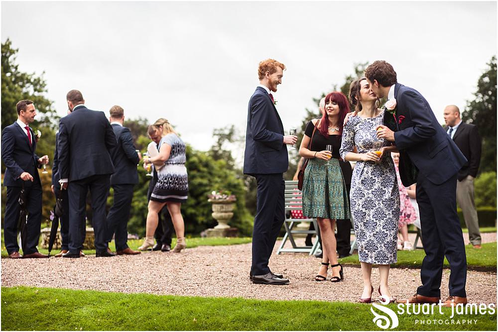 Capturing the fun of the afternoon as the guests relax and play the garden games at Sandon in Staffordshire by Documentary Wedding Photographer Stuart James