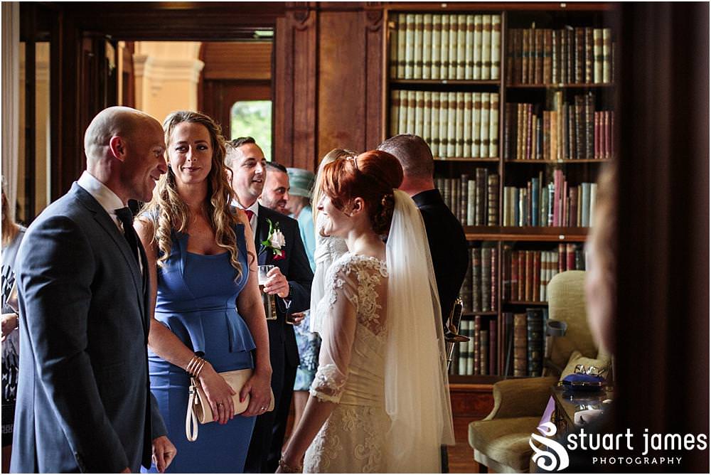 Storytelling photographs as the guests greet the bridal party ahead of the Alice in Wonderland wedding breakfast at Sandon in Staffordshire by Documentary Wedding Photographer Stuart James