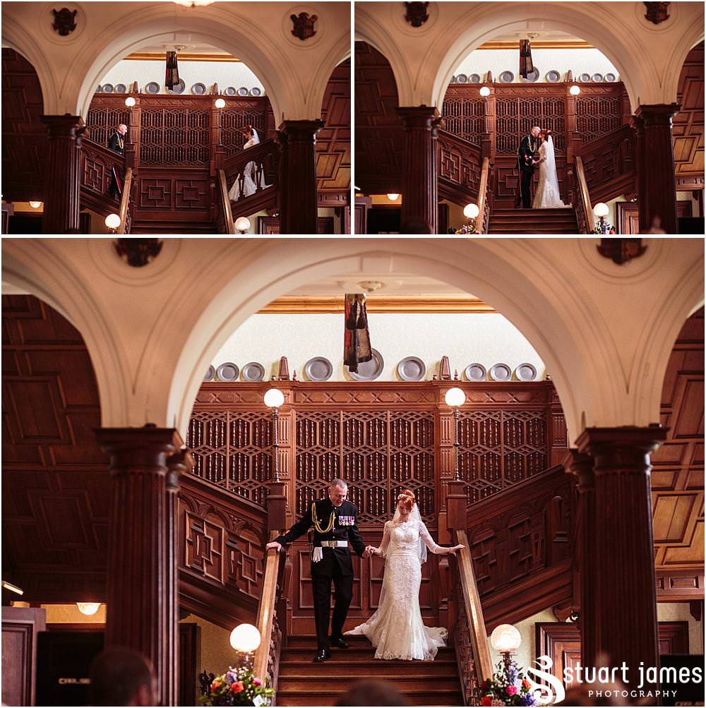 The wonderful entrance of the bride and groom down the grand staircase at Sandon in Staffordshire by Documentary Wedding Photographer Stuart James