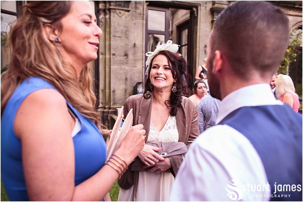 Candid photos of the guests enjoying the evening reception in the beautiful setting of Sandon in Staffordshire by Documentary Wedding Photographer Stuart James