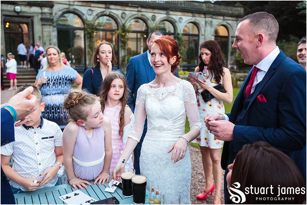 Fabulous moments to capture as Chris Peskett entertains the Bride and Groom and surrounding guests with wonderful close magic at Sandon in Staffordshire by Documentary Wedding Photographer Stuart James