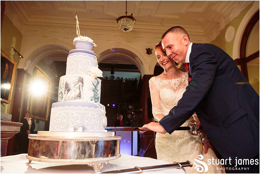 Cake cutting fun at Sandon in Staffordshire by Documentary Wedding Photographer Stuart James