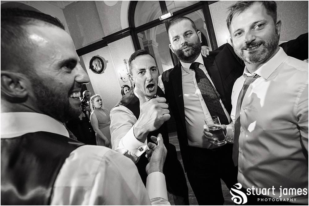 Creative photographs of the party getting underway in the beautiful saloon at Sandon in Staffordshire by Documentary Wedding Photographer Stuart James