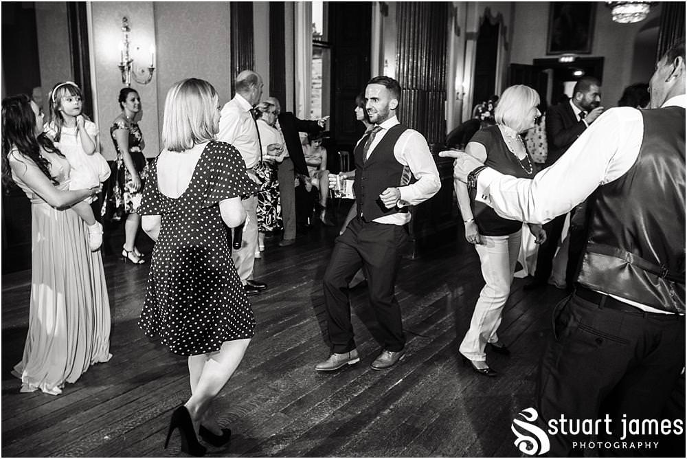 Creative photographs of the party getting underway in the beautiful saloon at Sandon in Staffordshire by Documentary Wedding Photographer Stuart James