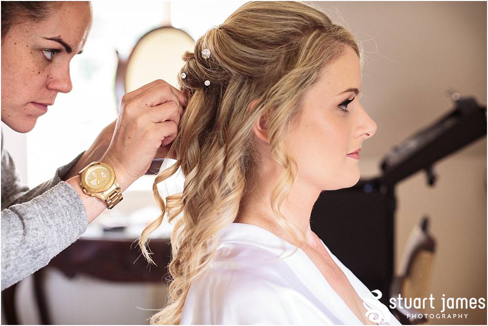 Creative photographs of the bridal hair and makeup at Warwick House in Southam by Documentary Wedding Photographer Stuart James