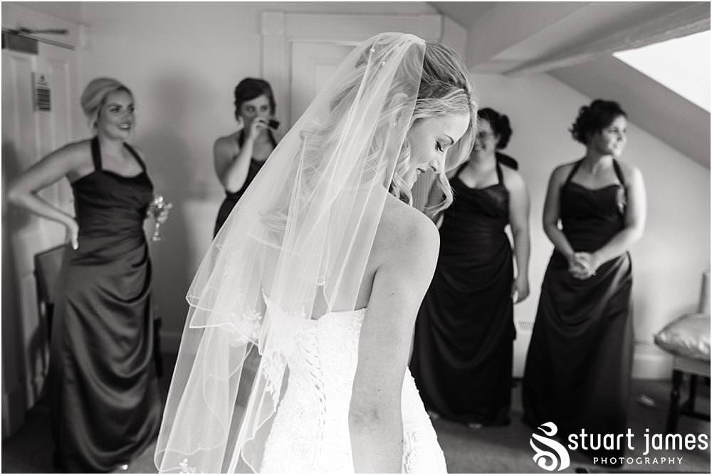 Documenting the beautiful and emotional reactions as the bride reveals her gown at Warwick House in Southam by Documentary Wedding Photographer Stuart James