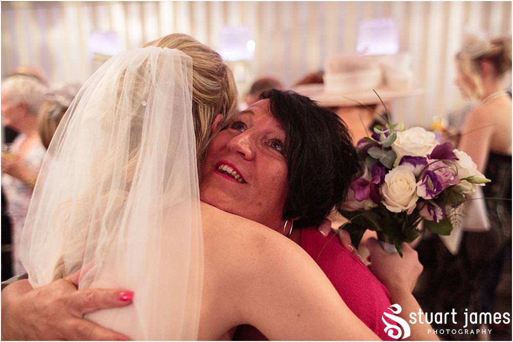 Beautiful moments as the guests greet the newly married couple at Warwick House in Southam by Documentary Wedding Photographer Stuart James