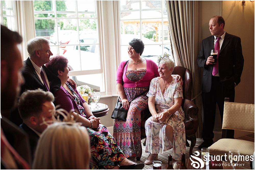 Creative candid photographs as the guests enjoy the drinks reception at Warwick House in Southam by Documentary Wedding Photographer Stuart James