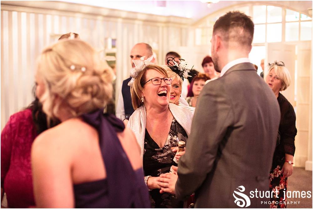 Creative candid photographs as the guests enjoy the drinks reception at Warwick House in Southam by Documentary Wedding Photographer Stuart James