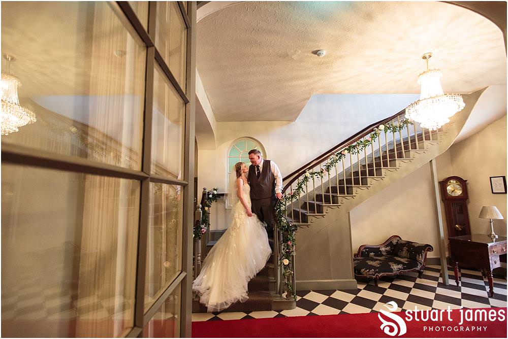 Creative evening portraits with the bride and groom on the staircase at Warwick House in Southam by Documentary Wedding Photographer Stuart James