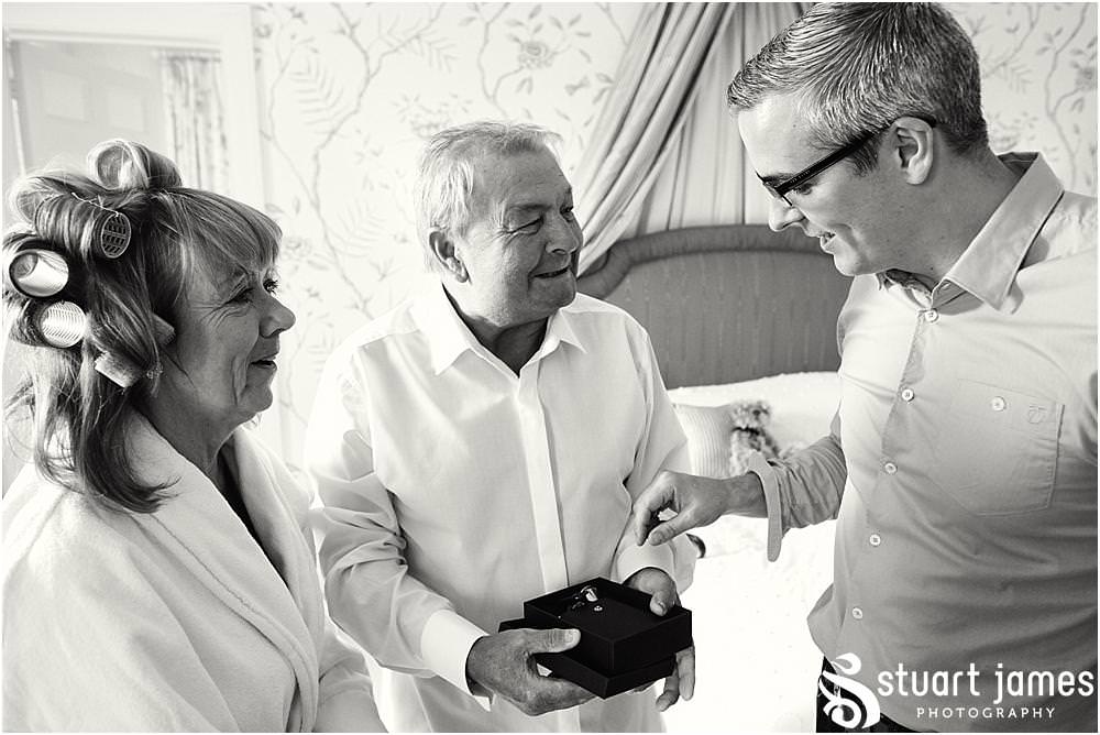 Capturing the wonderful reaction to the presentation of gifts during the wedding morning at Weston Park in Staffordshire by Documentary Wedding Photographer Stuart James