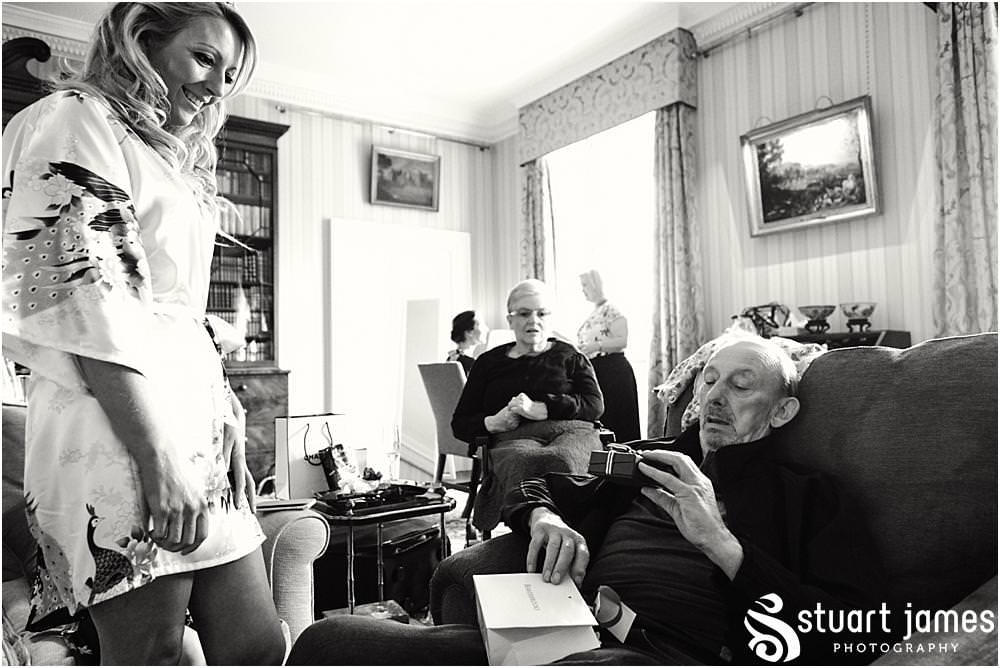 Capturing the wonderful reaction to the presentation of gifts during the wedding morning at Weston Park in Staffordshire by Documentary Wedding Photographer Stuart James