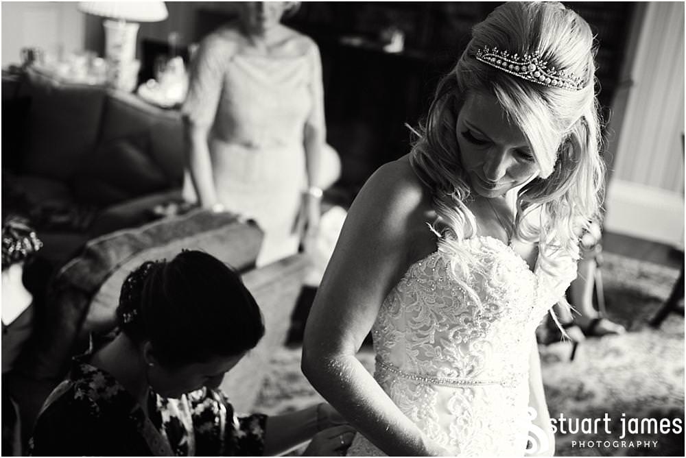 Finishing scenes as the bride dresses in her beautiful Maggie Sottero dress at Weston Park in Staffordshire by Documentary Wedding Photographer Stuart James