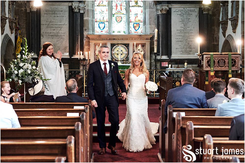 Capturing the end of the wedding ceremony at St Andrews Church in Weston Park, Staffordshire by Documentary Wedding Photographer Stuart James