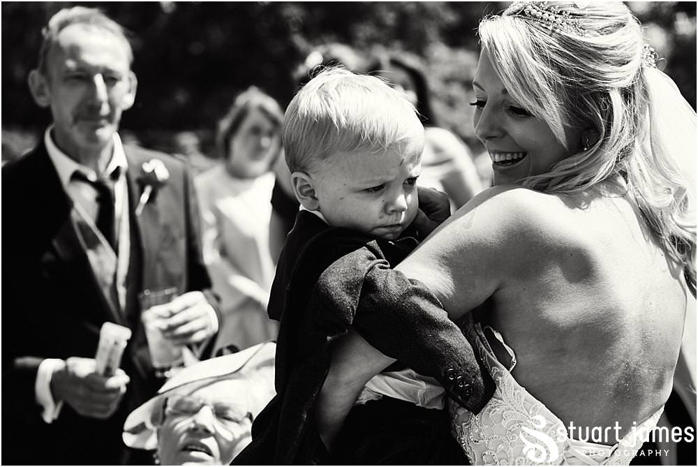 Creative candid photographs as the guests enjoy the drinks reception in the gardens at Weston Park in Staffordshire by Documentary Wedding Photographer Stuart James