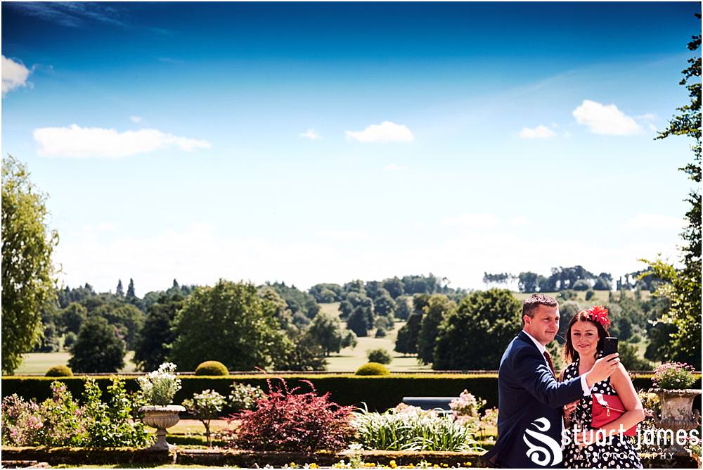 Creative candid photographs as the guests enjoy the drinks reception in the gardens at Weston Park in Staffordshire by Documentary Wedding Photographer Stuart James