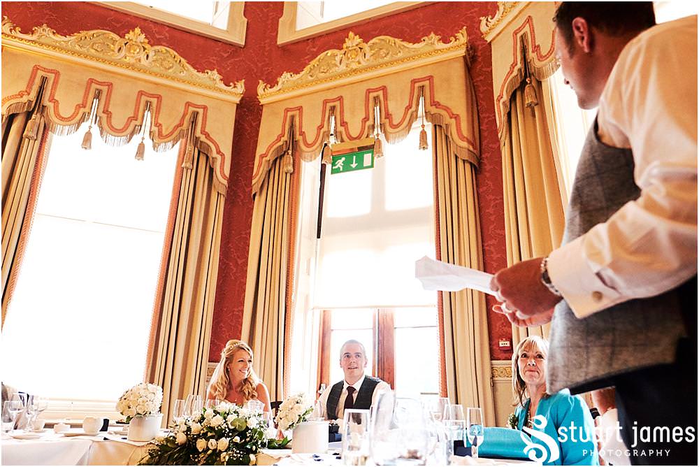 Capturing the fun and reaction to the stories of the best mans speech at Weston Park in Staffordshire by Documentary Wedding Photographer Stuart James