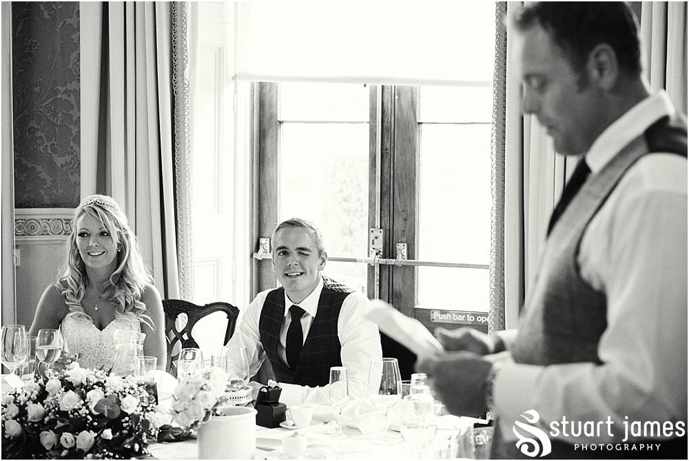 Capturing the fun and reaction to the stories of the best mans speech at Weston Park in Staffordshire by Documentary Wedding Photographer Stuart James
