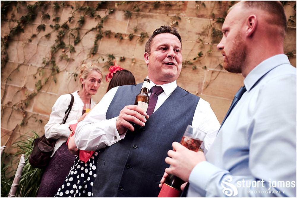 Candid photographs of the guests enjoying the evening reception at the fabulous setting of Weston Park in Staffordshire by Documentary Wedding Photographer Stuart James