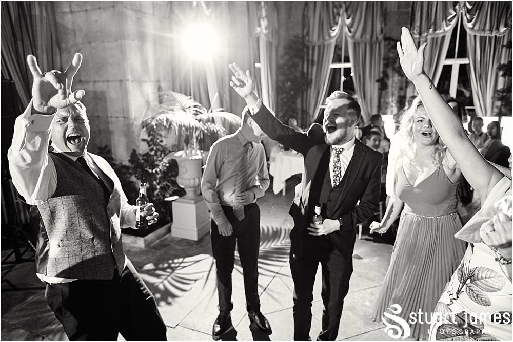 Creative photographs right in the middle of the party as the guests have a fabulous time in the Orangery at Weston Park in Staffordshire by Documentary Wedding Photographer Stuart James