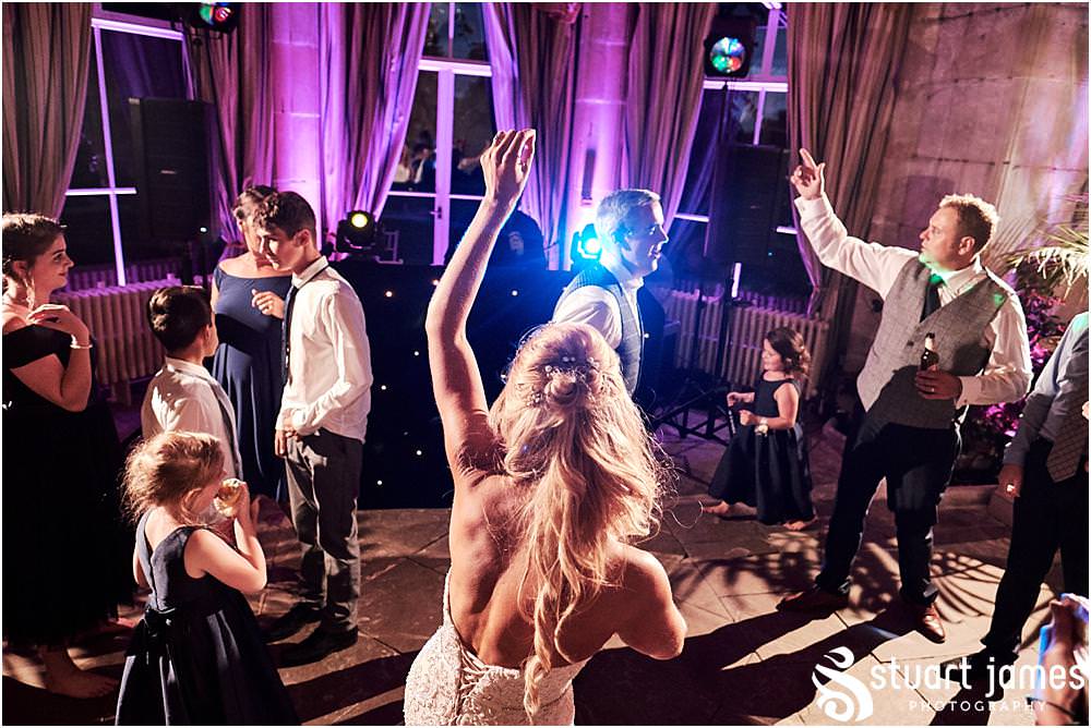 Creative photographs right in the middle of the party as the guests have a fabulous time in the Orangery at Weston Park in Staffordshire by Documentary Wedding Photographer Stuart James