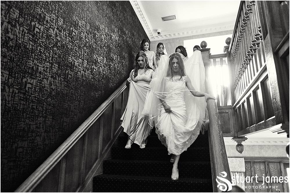 The perfect bride, heading down the stairs to her waiting father in the perfect gown from Silk bridal at St James Church in Acton Trussell by Documentary Wedding Photographer Stuart James