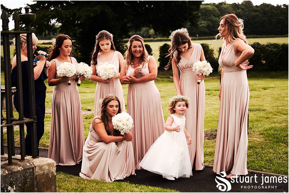 Capturing the arrival of the bridal party with Platinum Cars at St James Church in Acton Trussell by Documentary Wedding Photographer Stuart James