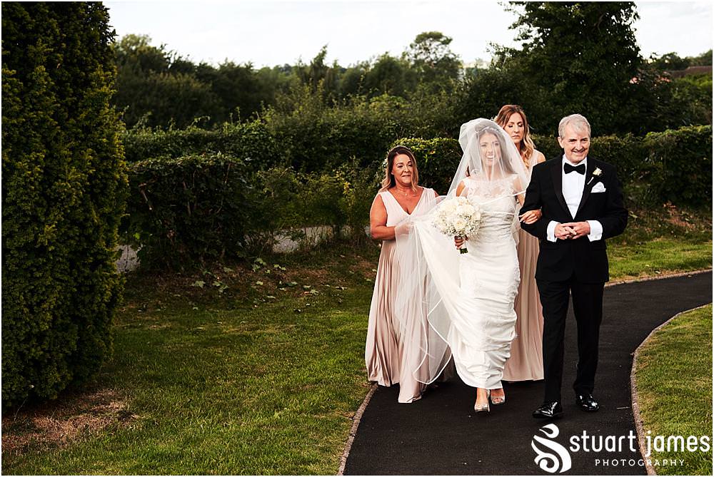 The arrival of the beautiful bride with her father at St James Church in Acton Trussell by Documentary Wedding Photographer Stuart James