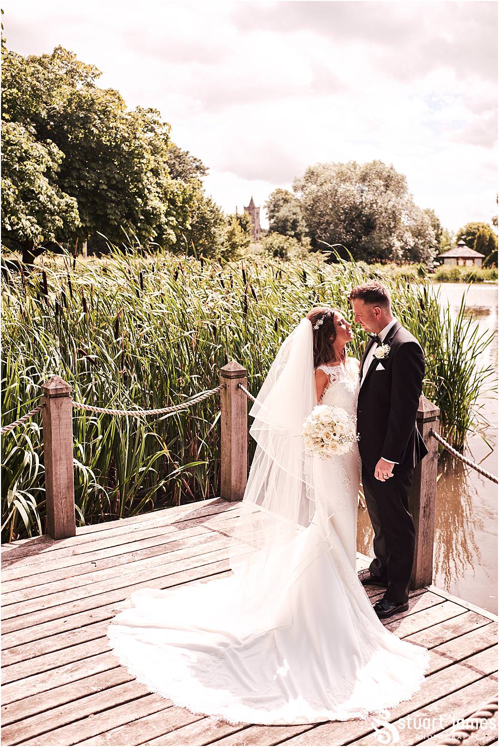 Creative relaxed portraits on the lakeside with the bride and groom at The Moat House in Acton Trussell by Documentary Wedding Photographer Stuart James