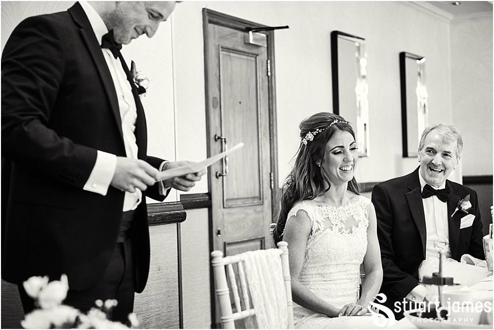 Creative documentary photography of the Grooms speech and the emotional and humorous reactions of the guests at The Moat House in Acton Trussell by Documentary Wedding Photographer Stuart James