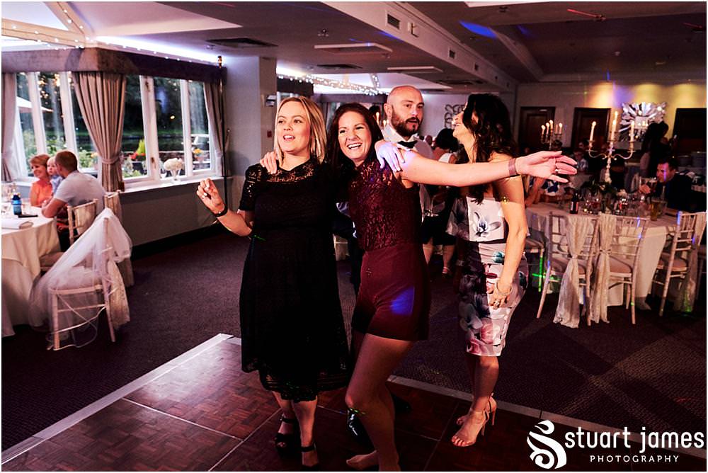 Capturing the fun of the evening reception as the guests party the night away at The Moat House in Acton Trussell by Documentary Wedding Photographer Stuart James