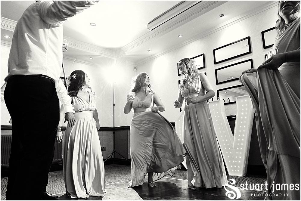 Capturing the fun of the evening reception as the guests party the night away at The Moat House in Acton Trussell by Documentary Wedding Photographer Stuart James