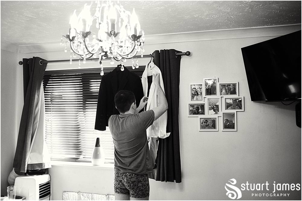 Documenting the preparations of the groom in his jacket and tartan trews at home in Bloxwich by Documentary Wedding Photographer Stuart James