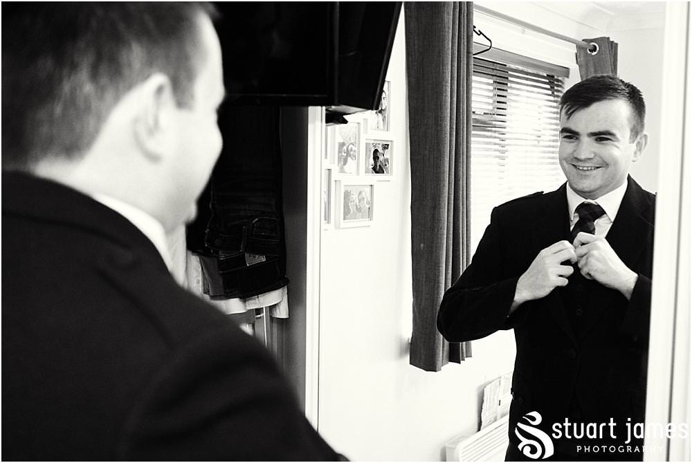 Documenting the preparations of the groom in his jacket and tartan trews at home in Bloxwich by Documentary Wedding Photographer Stuart James
