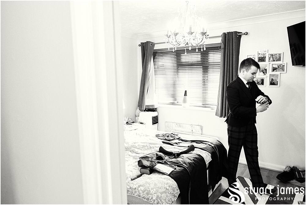 Documenting the preparations of the groom in his jacket and tartan trews at home in Bloxwich by Documentary Wedding Photographer Stuart James