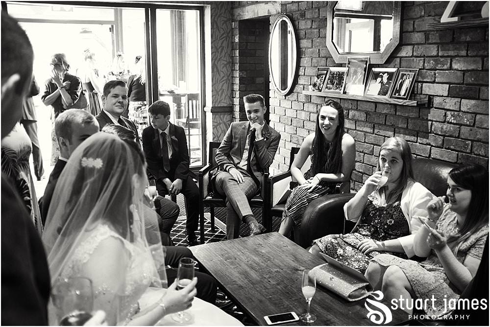 Candid photos of the guests relaxing in the wonderful setting at The Moat House in Acton Trussell by Documentary Wedding Photographer Stuart James