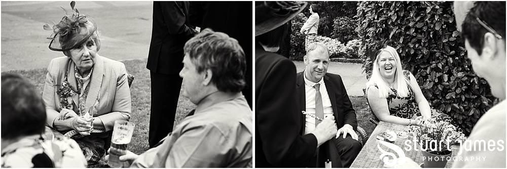 Candid photos of the guests relaxing in the wonderful setting at The Moat House in Acton Trussell by Documentary Wedding Photographer Stuart James